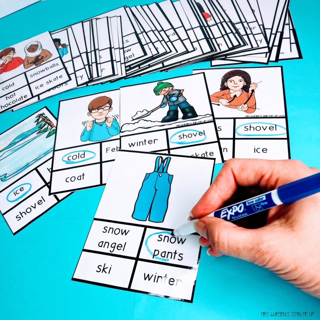 task cards featuring ASL Winter vocabulary the card showing is of snow pants and shows a person circling the English word with a dry erase marker